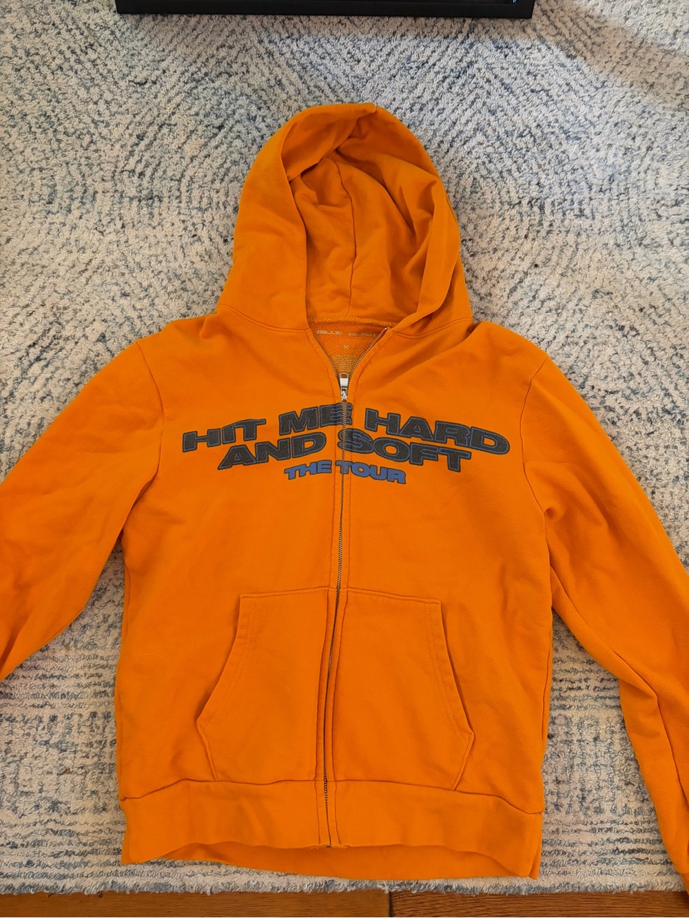 Orange Zip-Up Hoodie with 'Hit Me Hard and Soft' Graphic